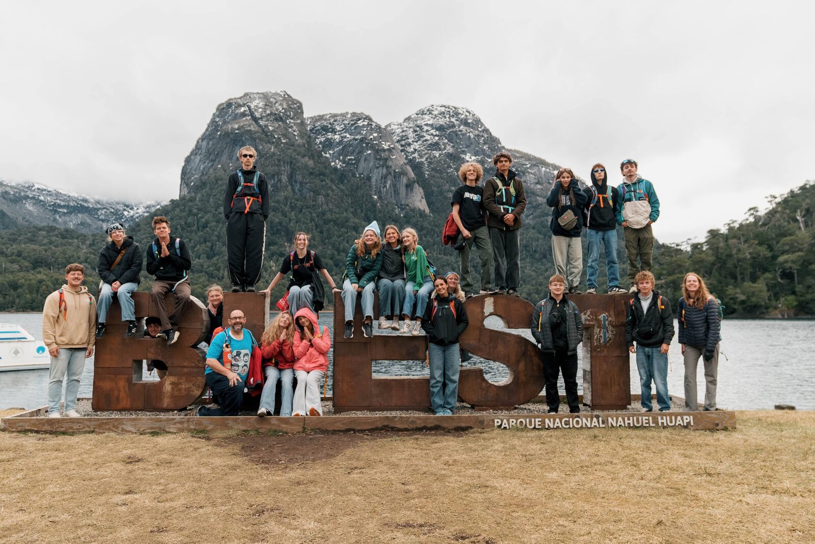 Builders on the B-E-S-T sign at a mountain lake