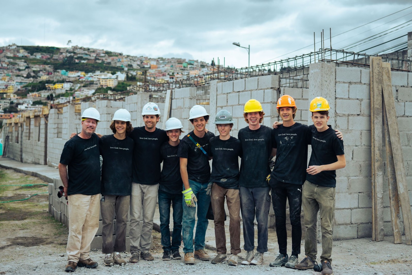 HXP builders standing together beside a community construction project